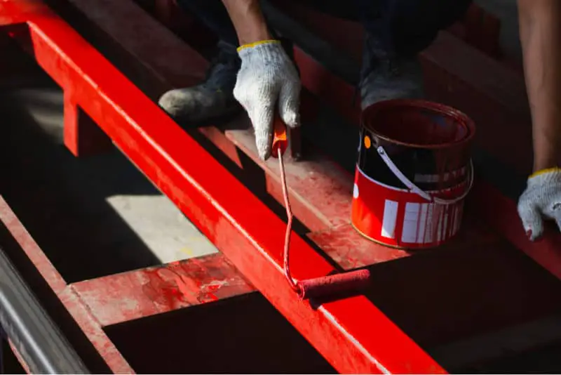applying oil based paint to steel tubing
